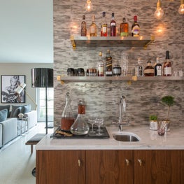Wet Bar with Gold Chain Light Fixture and Custom Cabinetry
