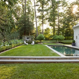 At Home pool area with lush grass