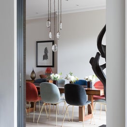 Open plan dining room, velvet chairs, stunning lighting