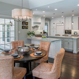 Breakfast room pops with tangerine accents and lovely view of patio and pool area