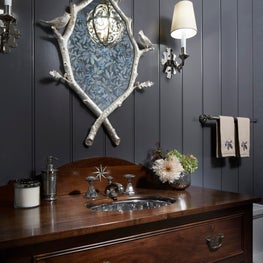 Lake Geneva Bathroom. Antique vanity with silver hardware, faux bois nature mirror & gray beadboard.