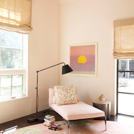 Reading nook in an NY home, pastel pink with hints of green, subtle artwork