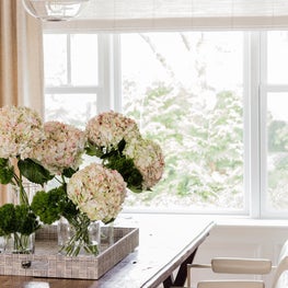 Old meets new dining room with glass statement lighting by John Pomp
