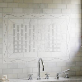 Marble mosaic tile detail over bathtub. Sophia Shibles Interiors