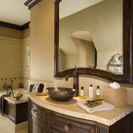 This young man’s bathroom is finished with chiseled stone, supple suede, and ancient fossil details.  