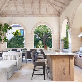 A covered outdoor grilling pavilion with a bleached cypress ceiling