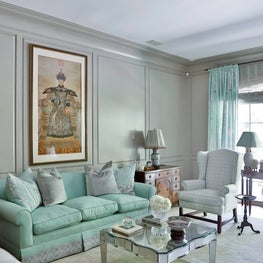 Mint color palette, mirrored coffee table, and old-world influences 