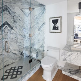 Dramatic book matched marble bathroom