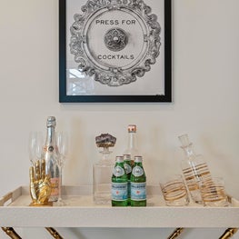 Contemporary tall tray stand stand acting as a makeshift bar and cocktail art.