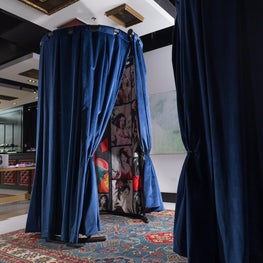 Velvet/geisha patterned curtains make the dressing rooms at men's luxury store