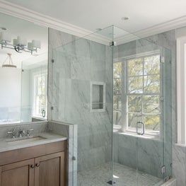 Carrara Marble Bathroom with Glass Shower, Window and Natural Wood Vanity