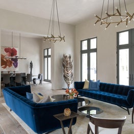 Modern colorful living room + blue velvet seating & Jonathan Browning fixtures