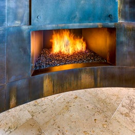 Clean lines and simple, unadorned panels give this fireplace a modern flair