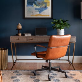 Navy home office w camel leather chair, modern desk and Tibetan rug