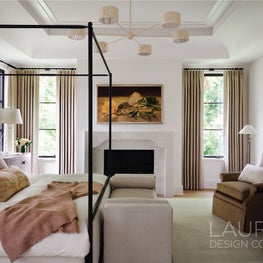 A plaster fireplace with reeded detailing and marble accents introduces gentle architecture and continuity within the private suite.