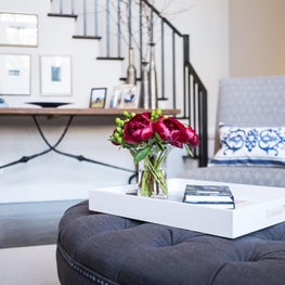 Living Room Ottoman with modern lacquer tray topped with peonies