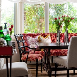 The vivid upholstery and heavily carved dark wood furniture are a perfect blend.