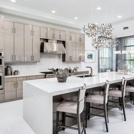 SLEEK CONTEMPORARY METALLIC RESIDENCE, silver itchen cabinets, large island, eat in kitchen, chandelier in kitchen, open concept kitchen