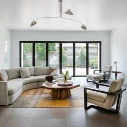 Living Room with Custom Curved Sectional and Vintage Accents