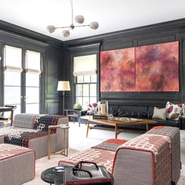 Living Room with Dark Gray Stained Walls and Orange Accents Throughout