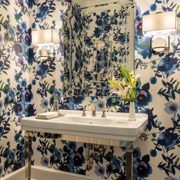 In the powder room we used a bold blue flower print wallpaper by York.