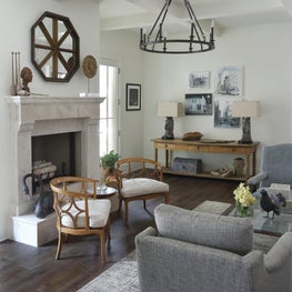 Serenbe Family Room with cast stone fireplace and antiques