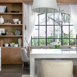 Portfolio: A high-end kitchen design with custom shelving and large marble island.