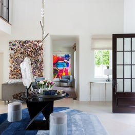 Portfolio: An entryway to a modern home in Pebble Beach with blue Tai Ping rug, cocktail table and amethyst decor.