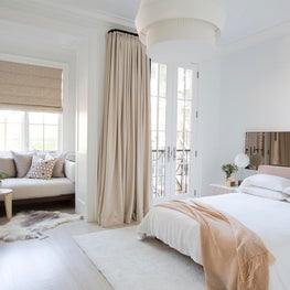 White organic white-on-white neutral modern bedroom with sitting area
