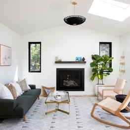 Bright living room with inset fireplace, geometric rug and contemporary seating