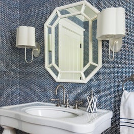 graphic navy wallpaper vintage Palm Beach mirror sconces in powder room