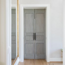 A beautiful vintage door sits at the entrance of the homeowner's primary suite.