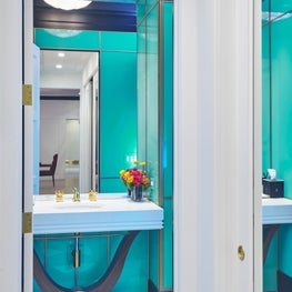 Glass Panel Powder Room with Art Deco Rosewood Vanity, Gold Accents