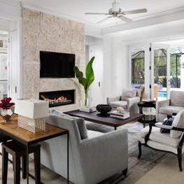 A (tropical) contemporary living room becomes romantic with a fireplace.