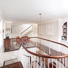 Second Floor Stair Hall with Curved Walnut Handrail and White Balusters