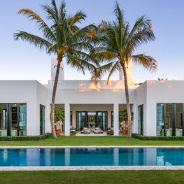 Steel doors define a symemtrical classical modern facade in Palm Beach