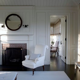 A Master Bedroom fireplace detail with sunroom beyond