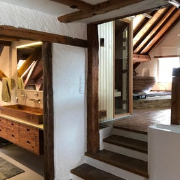 Swiss Chalet Master Bath with Trough Sink, Floating Vanity, and Freestanding Tub