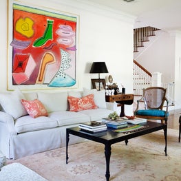 Transitional living room for Louisiana family - a mix of antiques and modern art