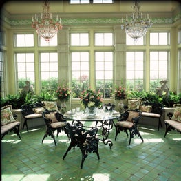 Sunroom featuring iconic chandeliers. 