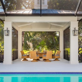 This pergola provides a perfect dining area on the far edge of the pool.