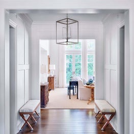 Hallway, White Walls, Circa Lighting Chandelier and Table Lamps, Cream Carpet, Cream Sofa, Neutral Palette, Benches, Pagoda Red Console, Noir Furniture Chests - Ravinia Residence Project