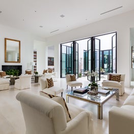 Large open living area with views to the interior courtyard through steel doors