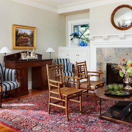 Historic Lake House Great Room. Fireplace seating with antique silver bar decor & Paul Ferrante chair.