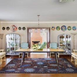 Dining room featuring Tlaquepapue plates, vitrine glass displays & Odegard rug