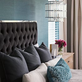 Bedroom rich with texture, tufted bed and crystal w/ chrome pendant lighting.