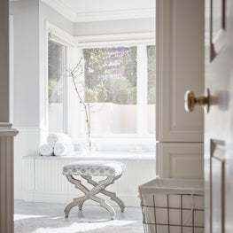 Whisper White Master Bathroom with Soaking Tub and Upholstered Stool