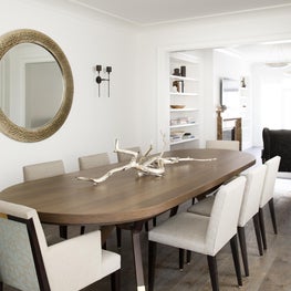 Clean sleek transitional contemporary dining room with white walls, wood table