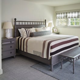 Lake Geneva Bedroom. Taupe, brown and ivory camp blanket on gray bamboo bed with Elkins-esque lamps.