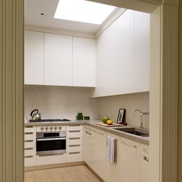 White kitchen with skylight and sleek cabinetry
